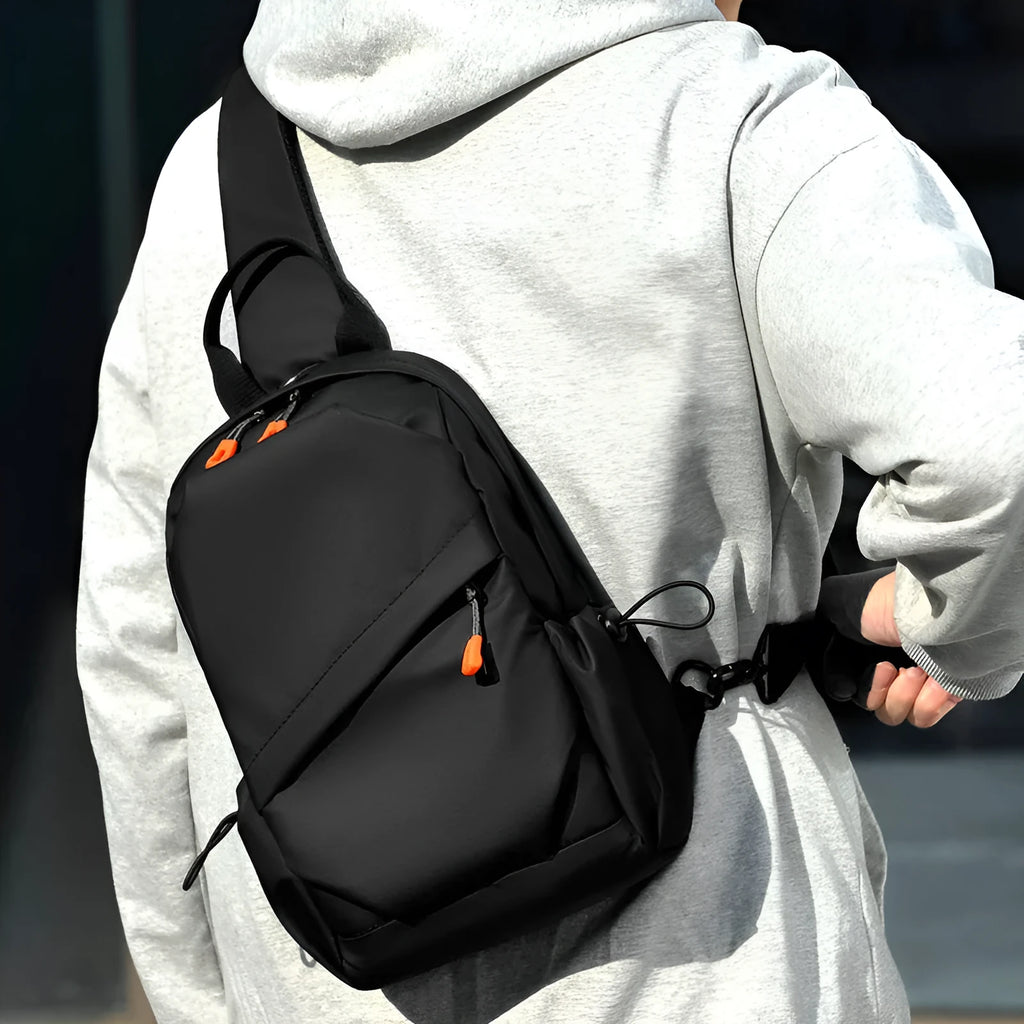 Men's black polyester crossbody bag worn on single shoulder with adjustable strap