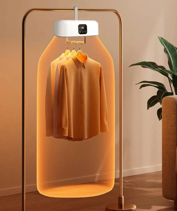 White cylindrical portable clothes dryer with remote control folded for storage
