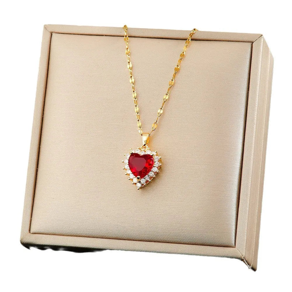 Gold red titanium steel jewellery set with heart and flower pendant necklace, stud earrings, and ring.