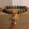 Colourful women's bracelet with butterfly charm and bead accents on alloy band
