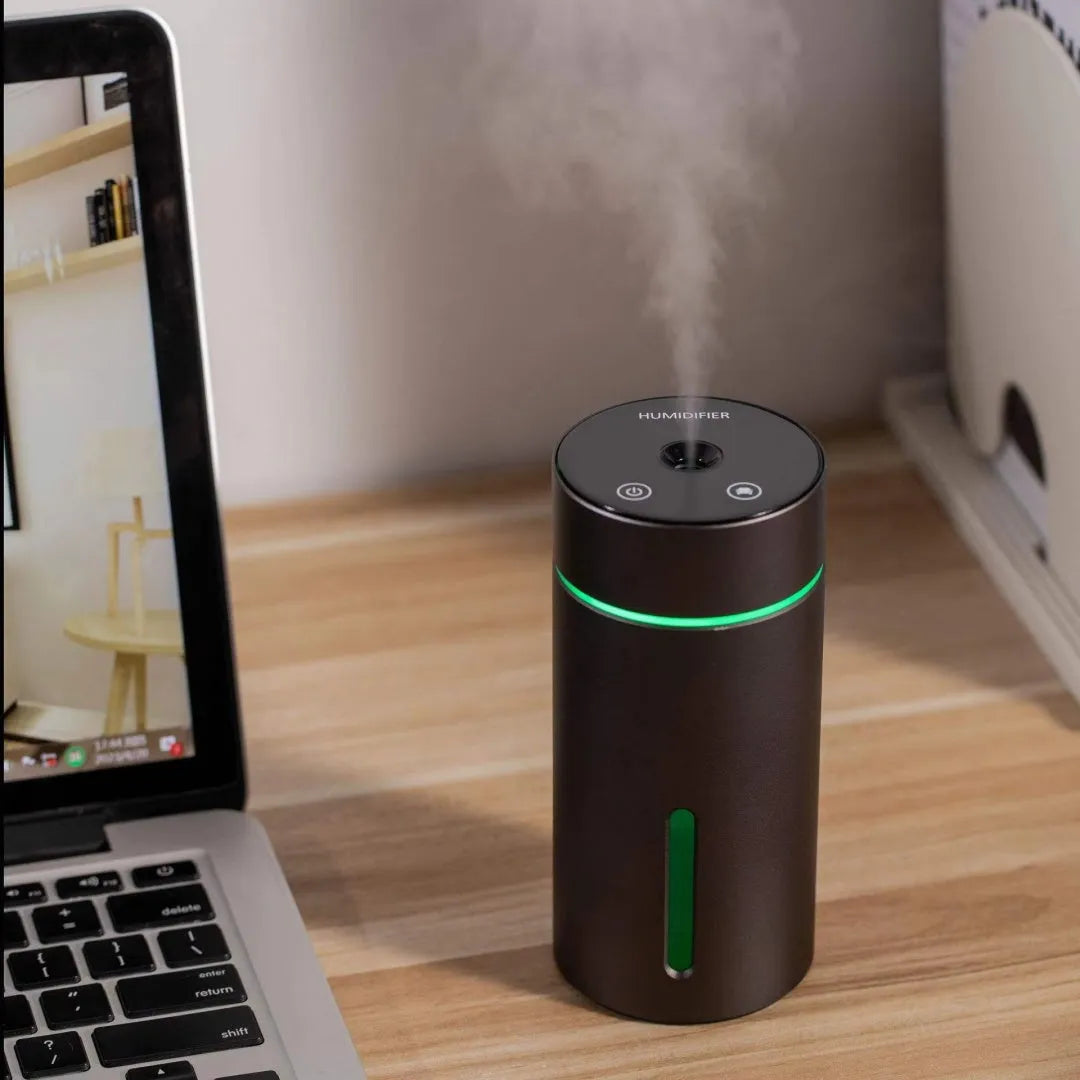 Black portable car humidifier and essential oil diffuser with aluminium body and colourful night light on