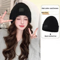 Hat wig for women with big wave curls in brown black colour, protein filament hair on mannequin
