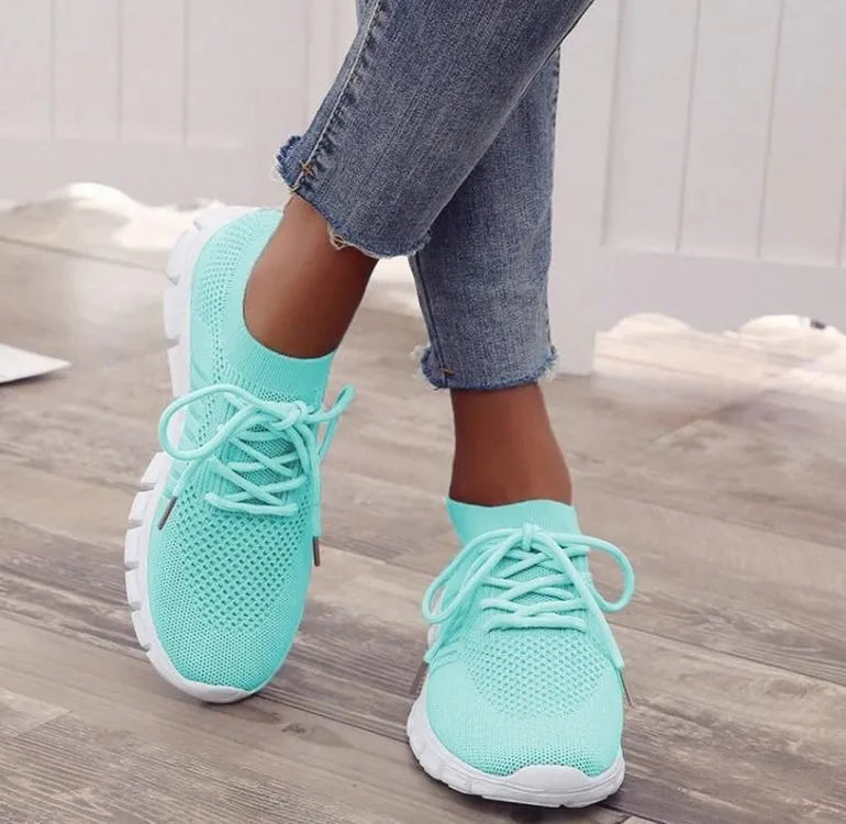 High-cut lace-up platform sneaker in a casual style with a breathable fabric upper and flat rubber sole.