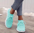 High-cut lace-up platform sneaker in a casual style with a breathable fabric upper and flat rubber sole.
