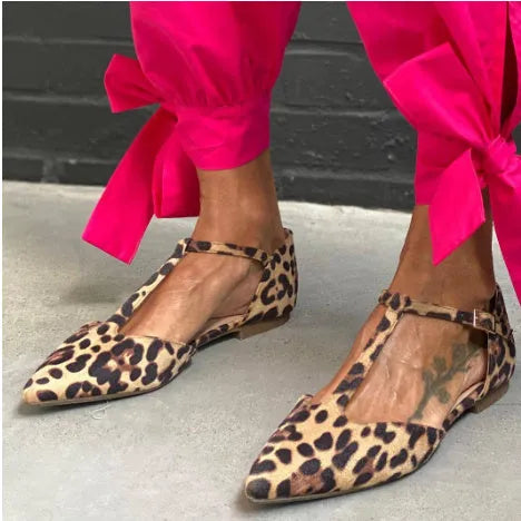 Leopard print women's pumps with pointed toe, cross straps, and low chunky heel