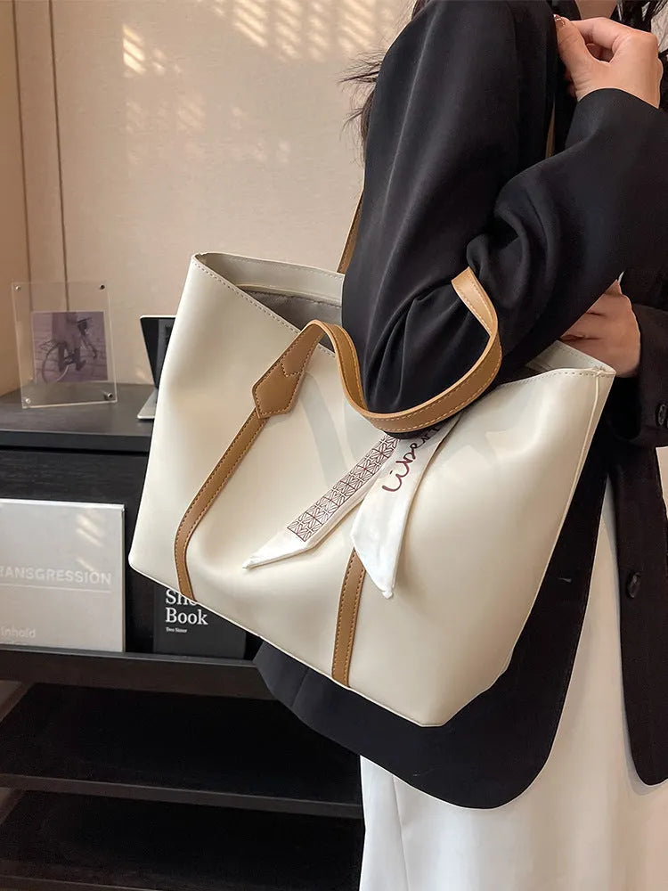 Soft large tote shoulder bag with crossbody strap in multiple colour options including black, khaki, and white with coloured trim
