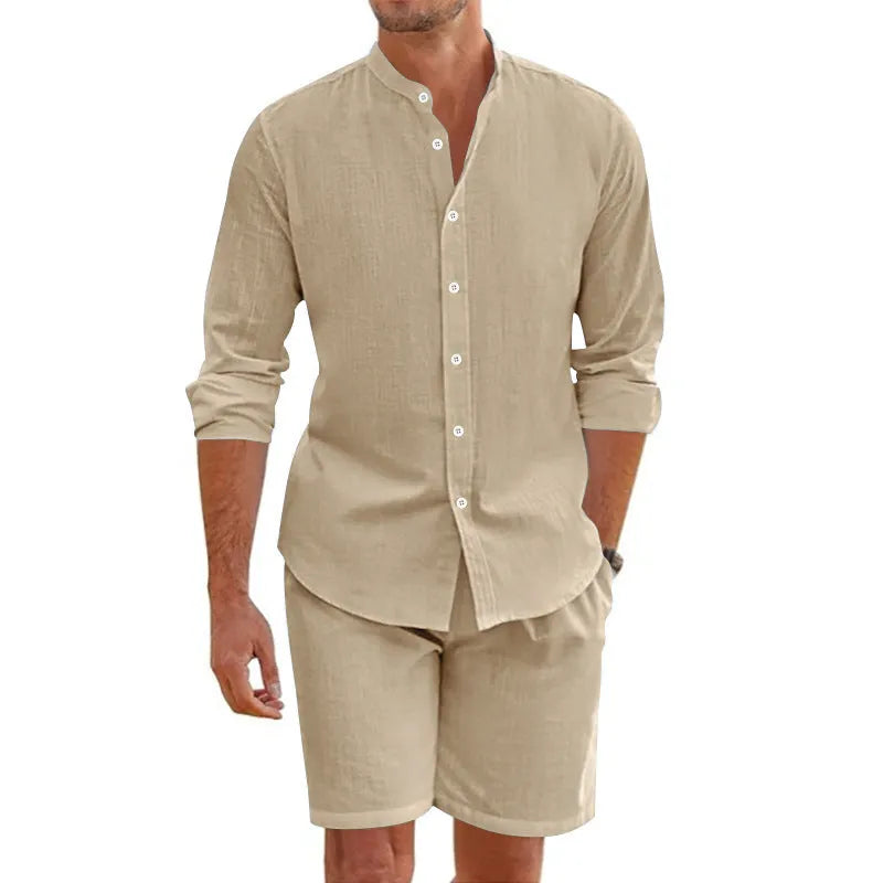 Men's dark grey linen blend summer suit with button-down short sleeve shirt and drawstring shorts.