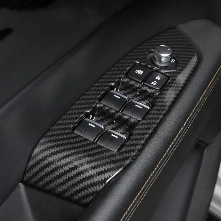 Pair of left and right ABS steering wheel frame trims with carbon fibre pattern for adhesive installation.