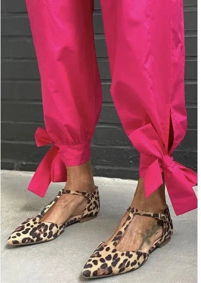 Leopard print women's pumps with pointed toe, cross straps, and low chunky heel