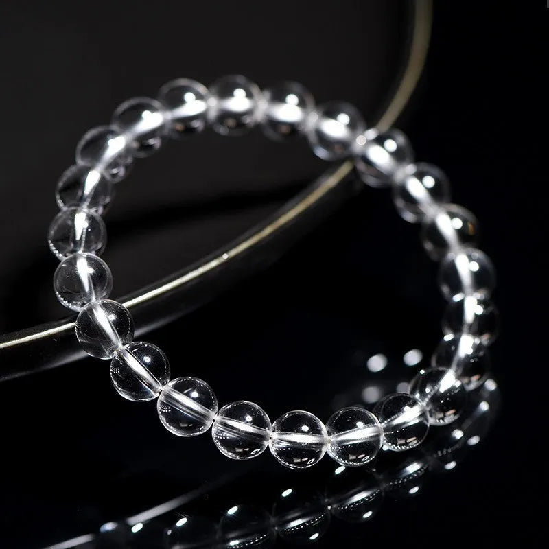 Natural old mine white crystal bracelet with round geometric beads on a wrist.