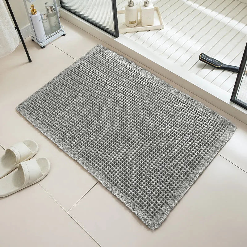 Checkered pattern non-slip absorbent bathroom floor carpet in beige colour.