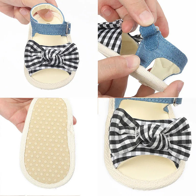 White and black Velcro baby shoes for toddlers, showing low-cut design and strap detail.