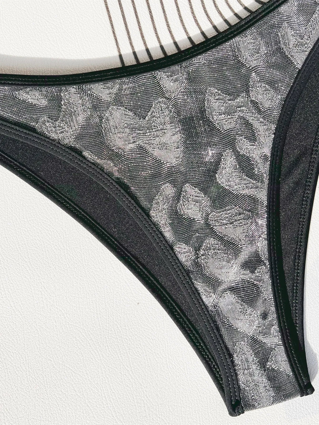 Black ladies bikini strap swimsuit set on white background