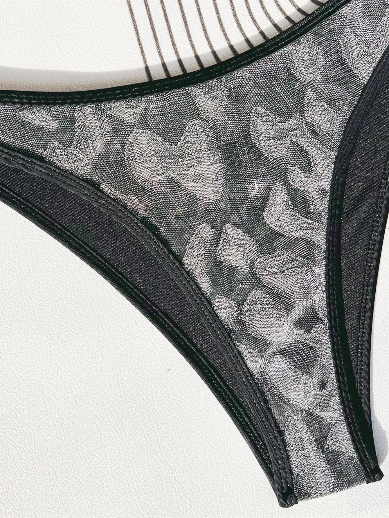 Black ladies bikini strap swimsuit set on white background