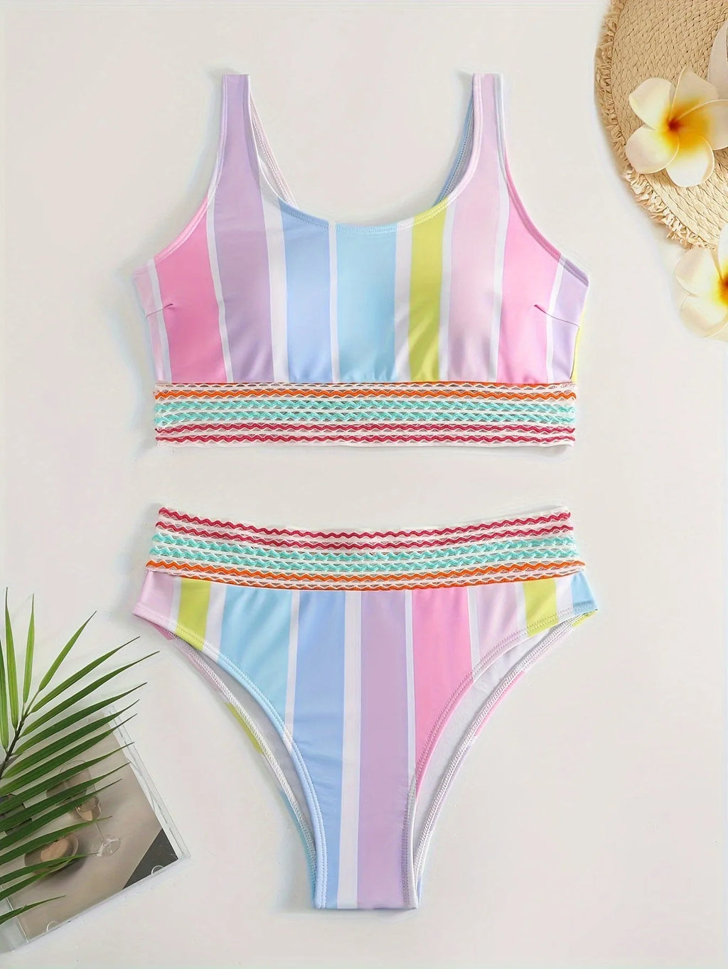 Women's striped sports bikini top and pants set on a mannequin.