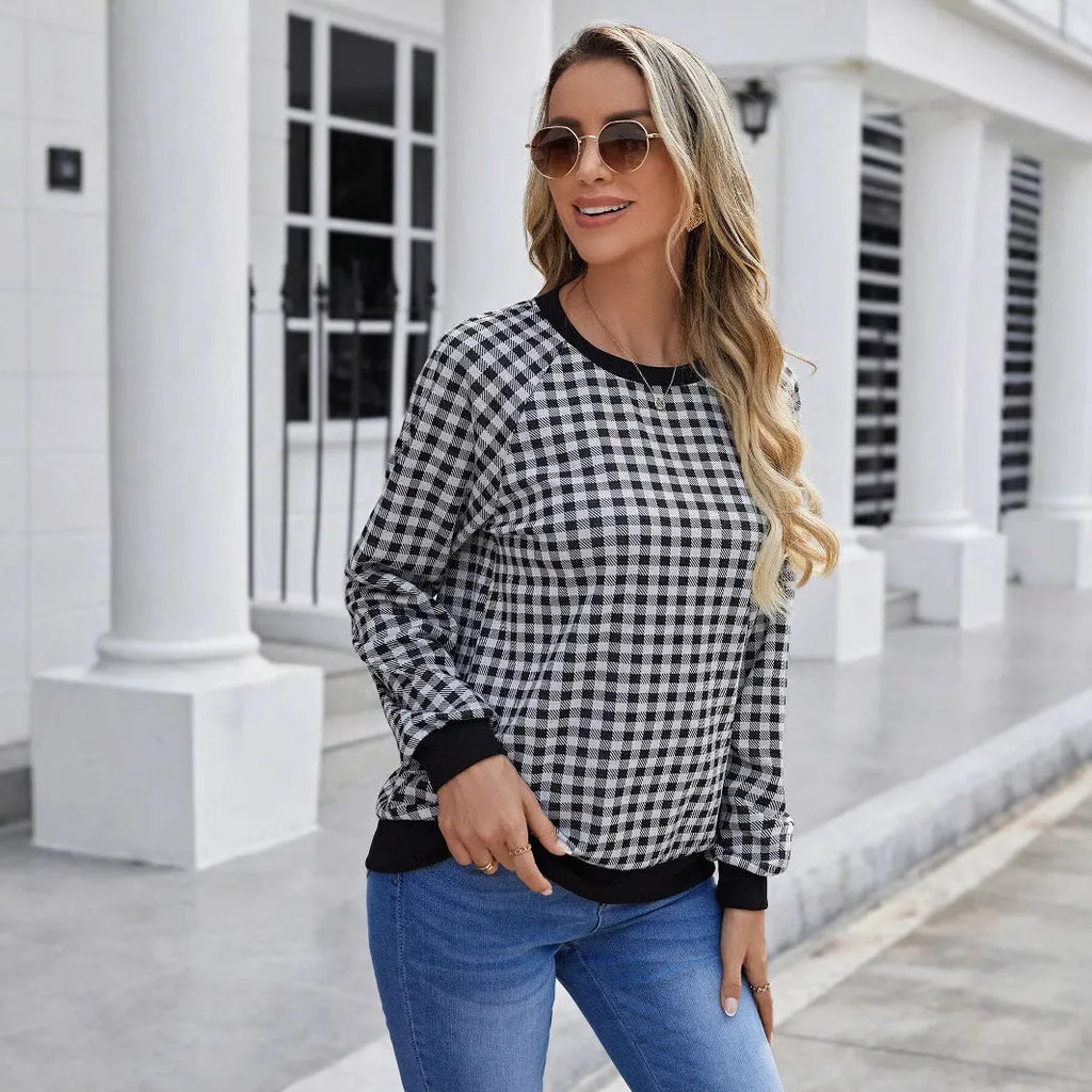 Black long sleeve polyester sweater with a plaid pattern, shown on a hanger.