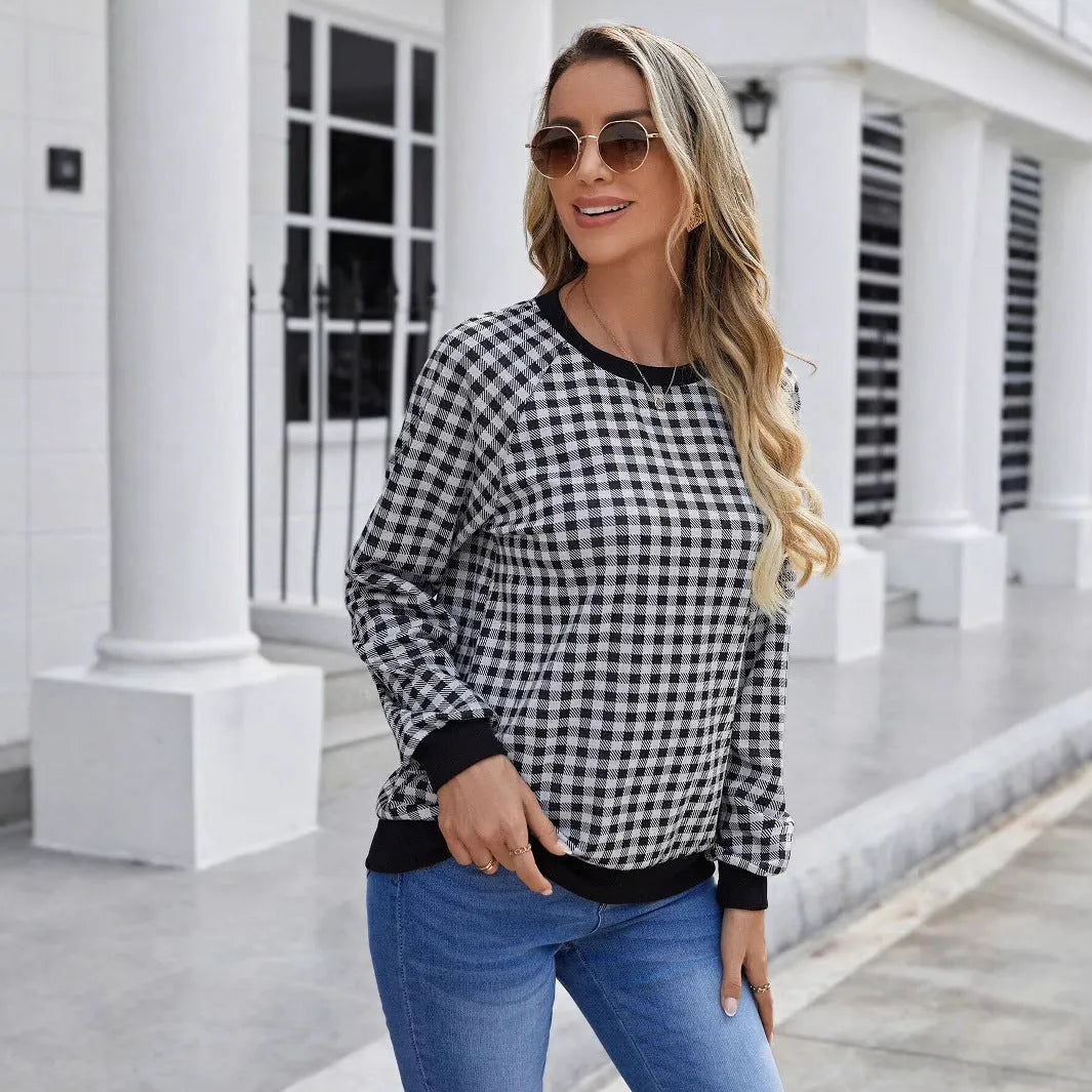 Black long sleeve polyester sweater with a plaid pattern, shown on a hanger.