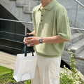 Men's caramel coloured retro knitted polo shirt with short sleeves and an asymmetrical design detail, laid flat.