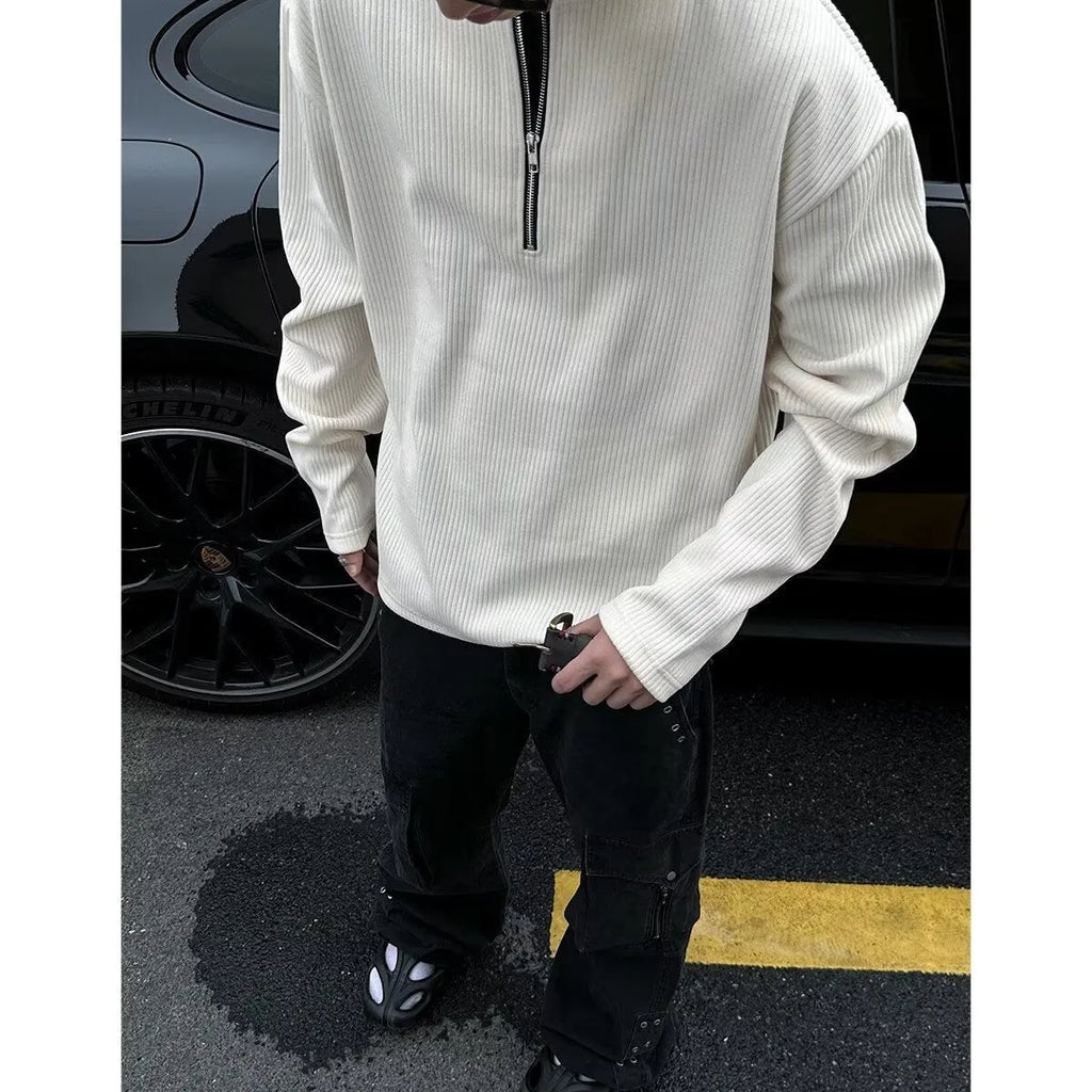 A grey women's loose-fitting long sleeve pullover top with a small letter pattern, shown on a hanger.
