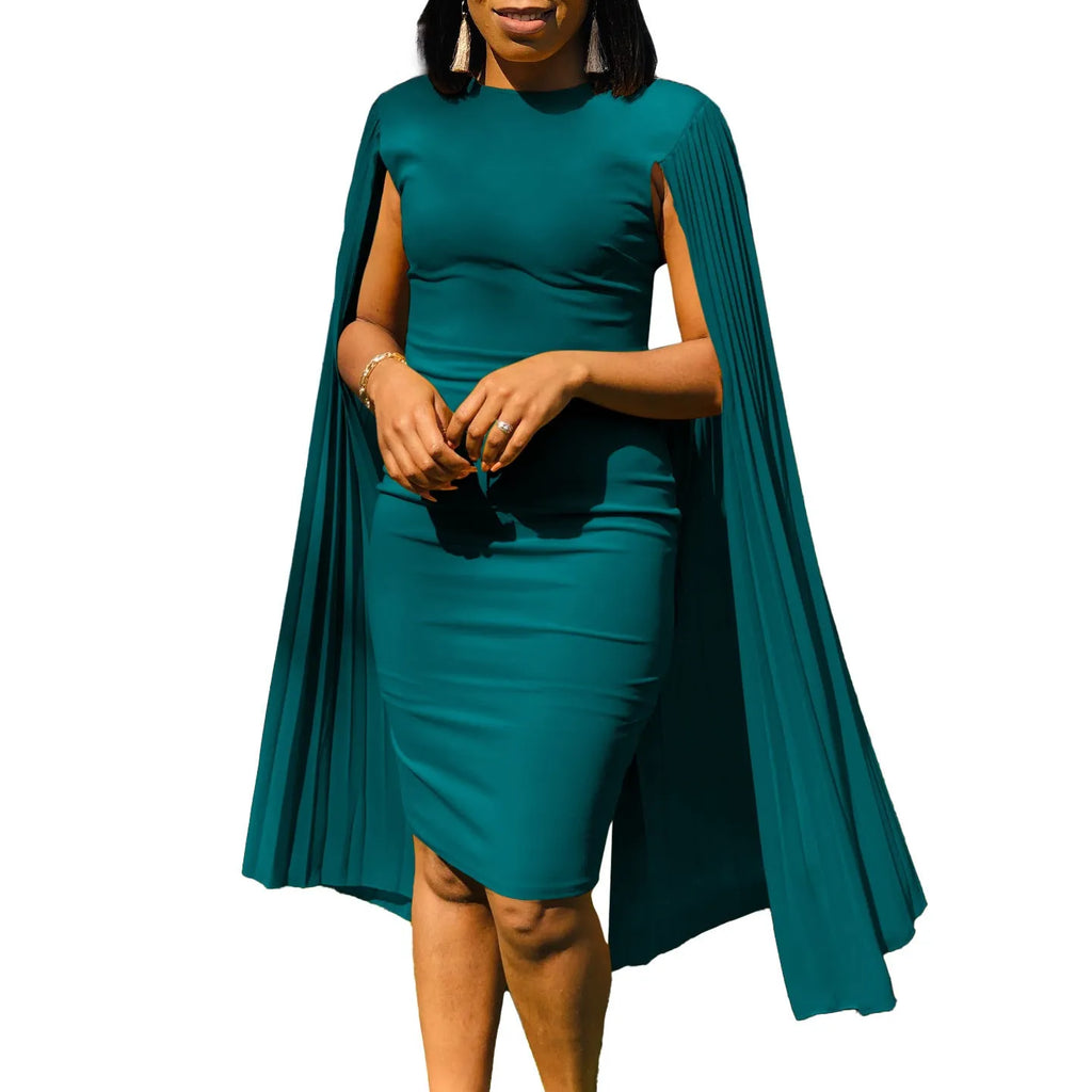 A woman wearing a long sleeve, high-waisted pleated evening gown in a formal setting.