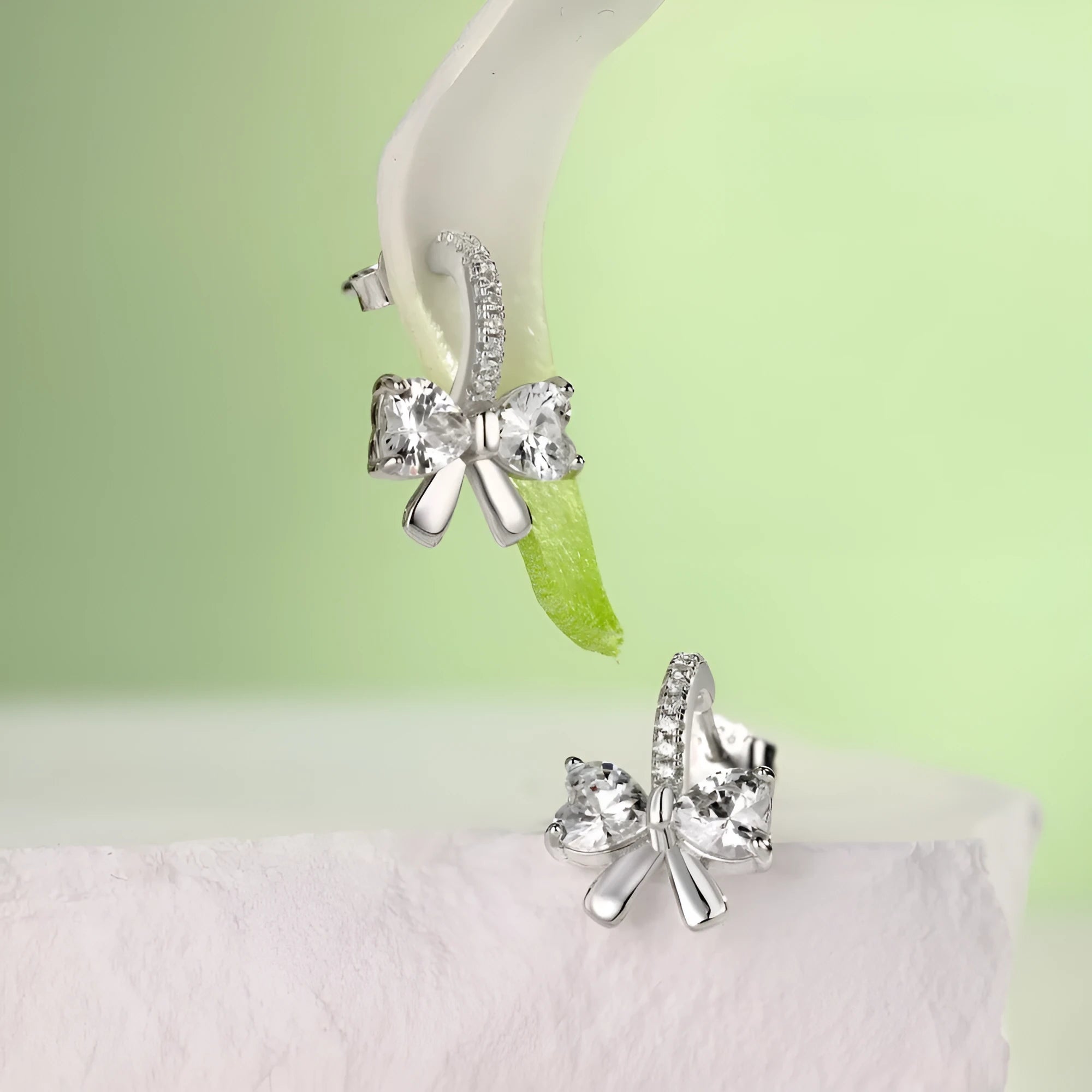 925 silver bowknot ear studs electroplated platinum finish on white background