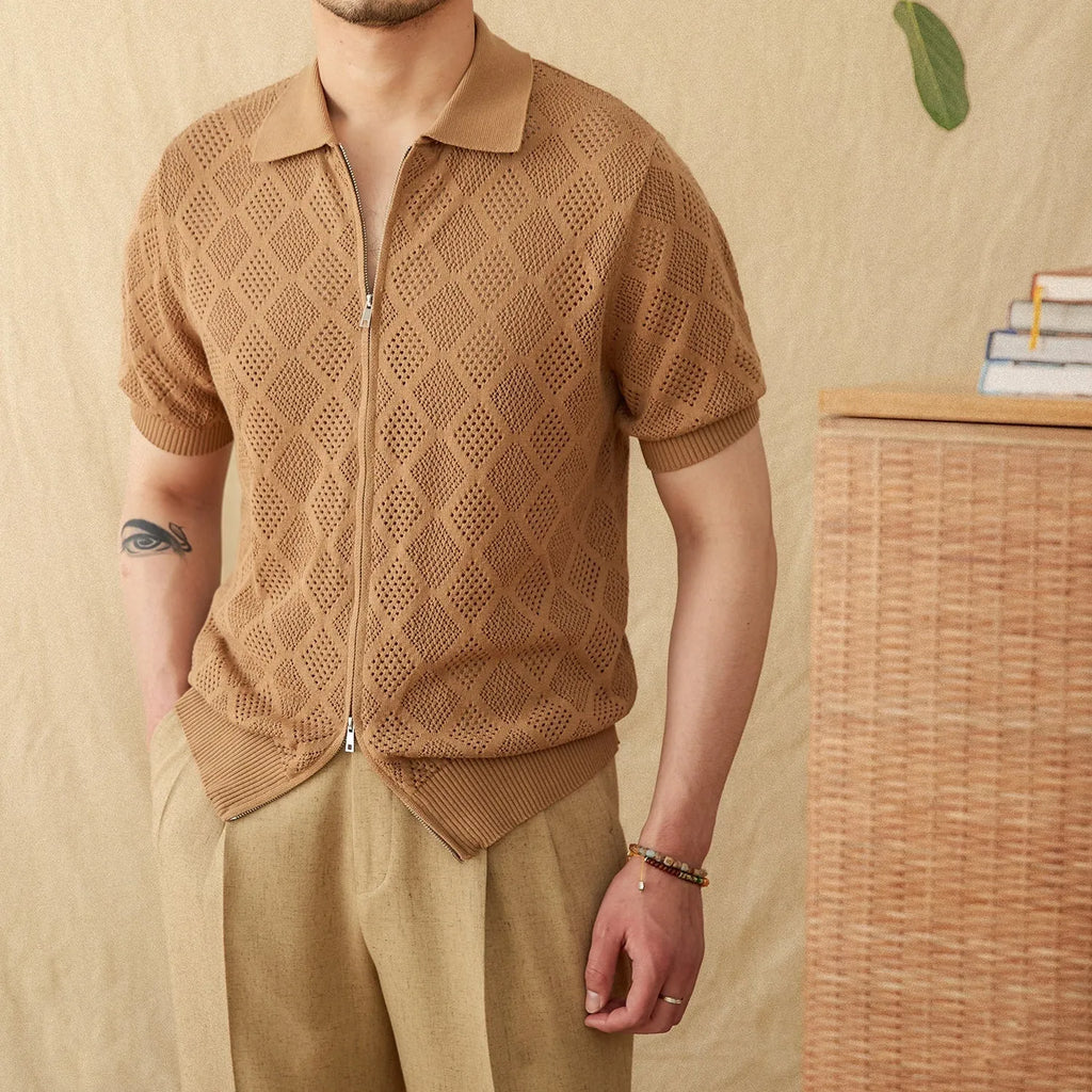 Light brown short sleeve cotton cardigan with a front zipper and lapel collar laid flat.