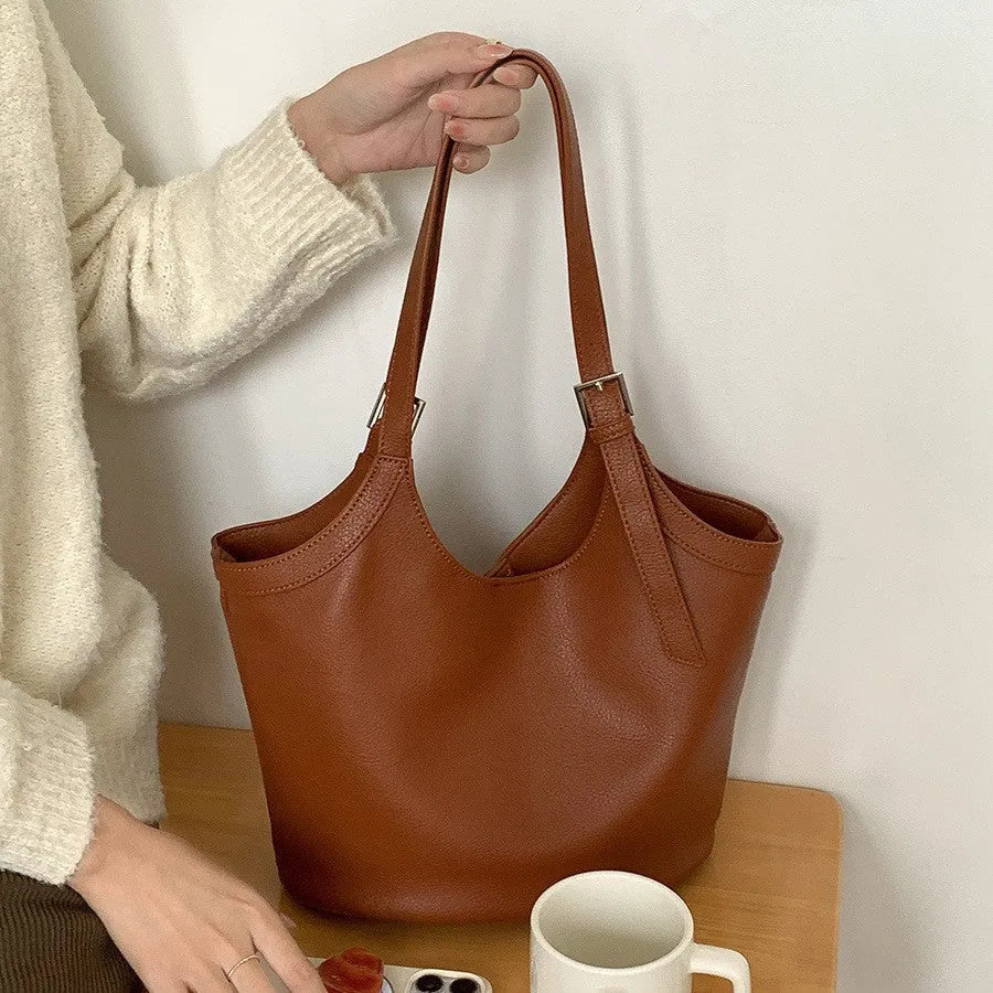 Idle Style light retro PU soft leather large capacity commuter shoulder bag in black with bucket shape and double straps