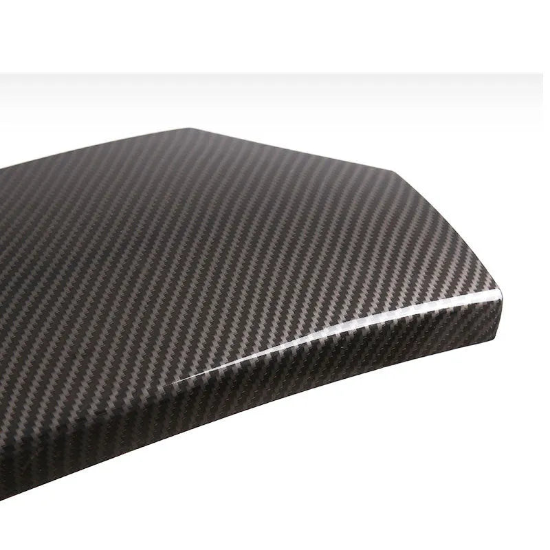Three black ABS car armrest protective covers with a shiny diagonal carbon fibre weave pattern.