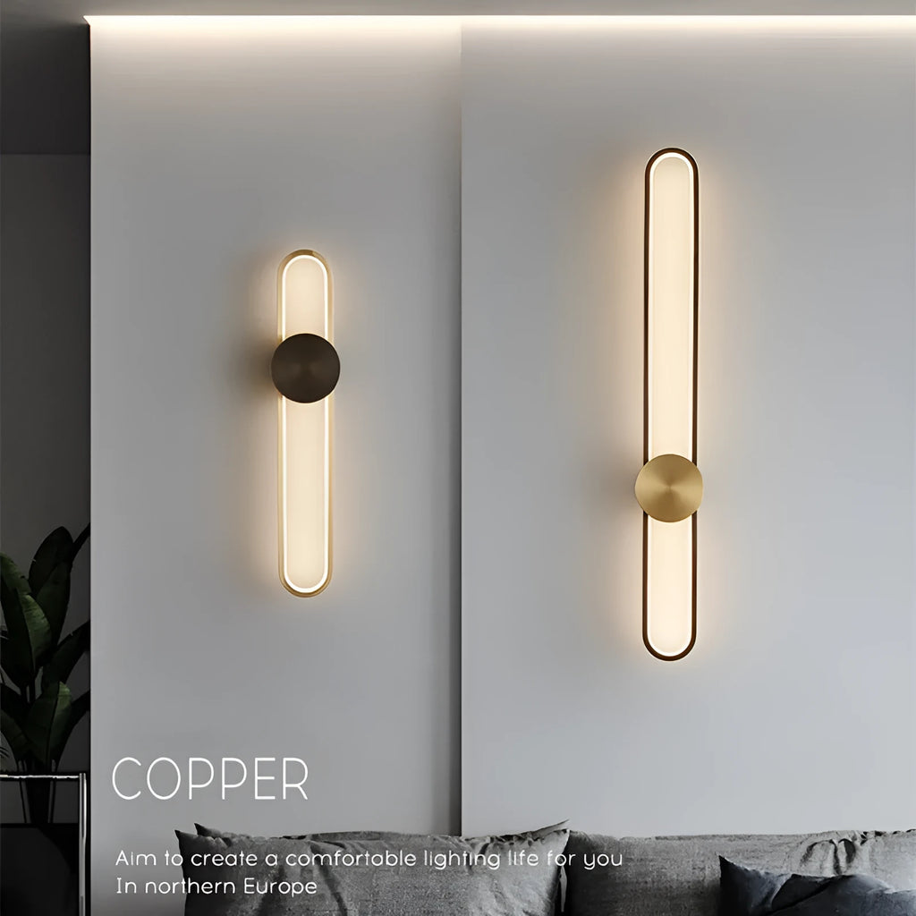 Round minimalist iron wall lamp with warm white LED light in black or gold finish.