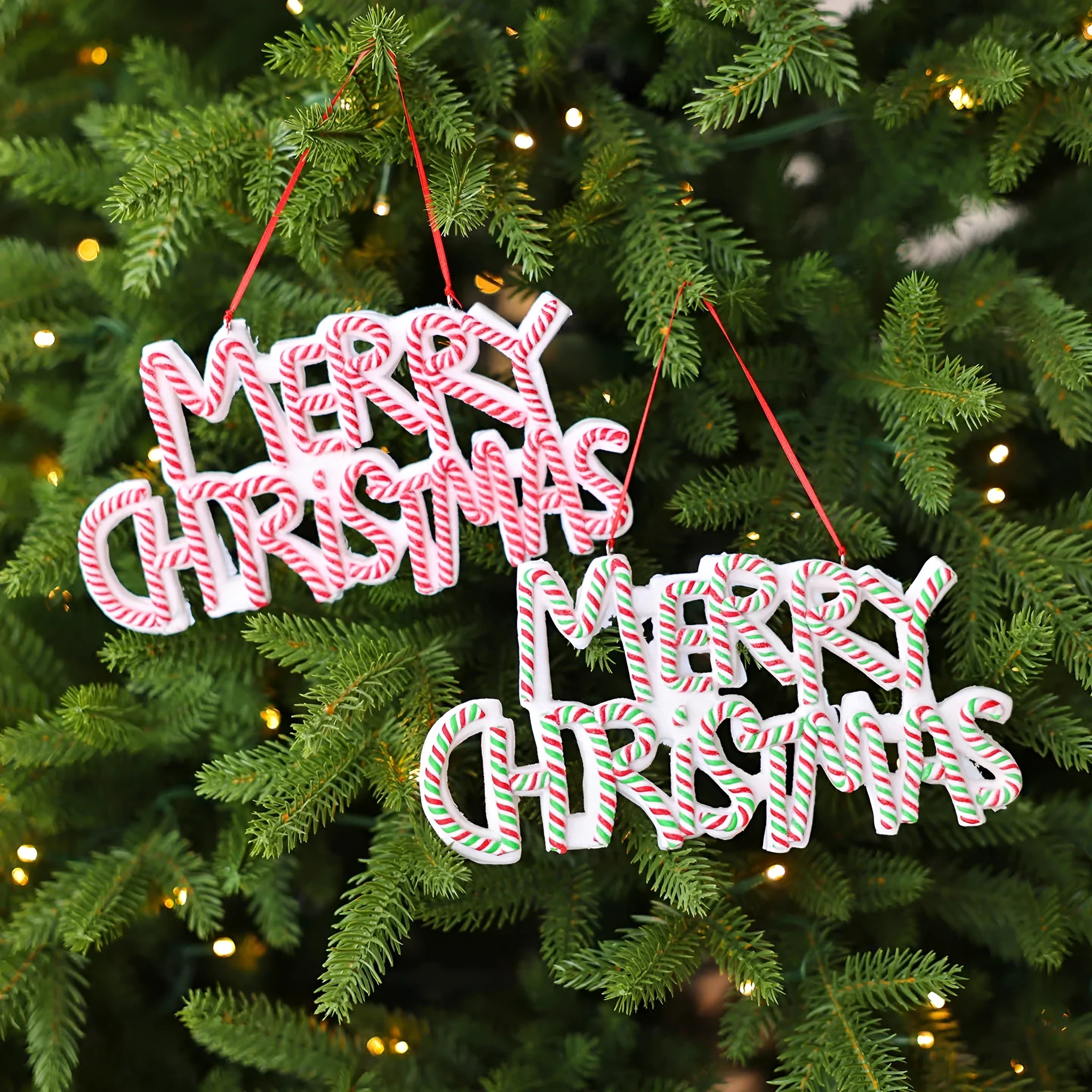 Merry Christmas letter plate polymer clay ornament in red and white hanging on Christmas tree branch