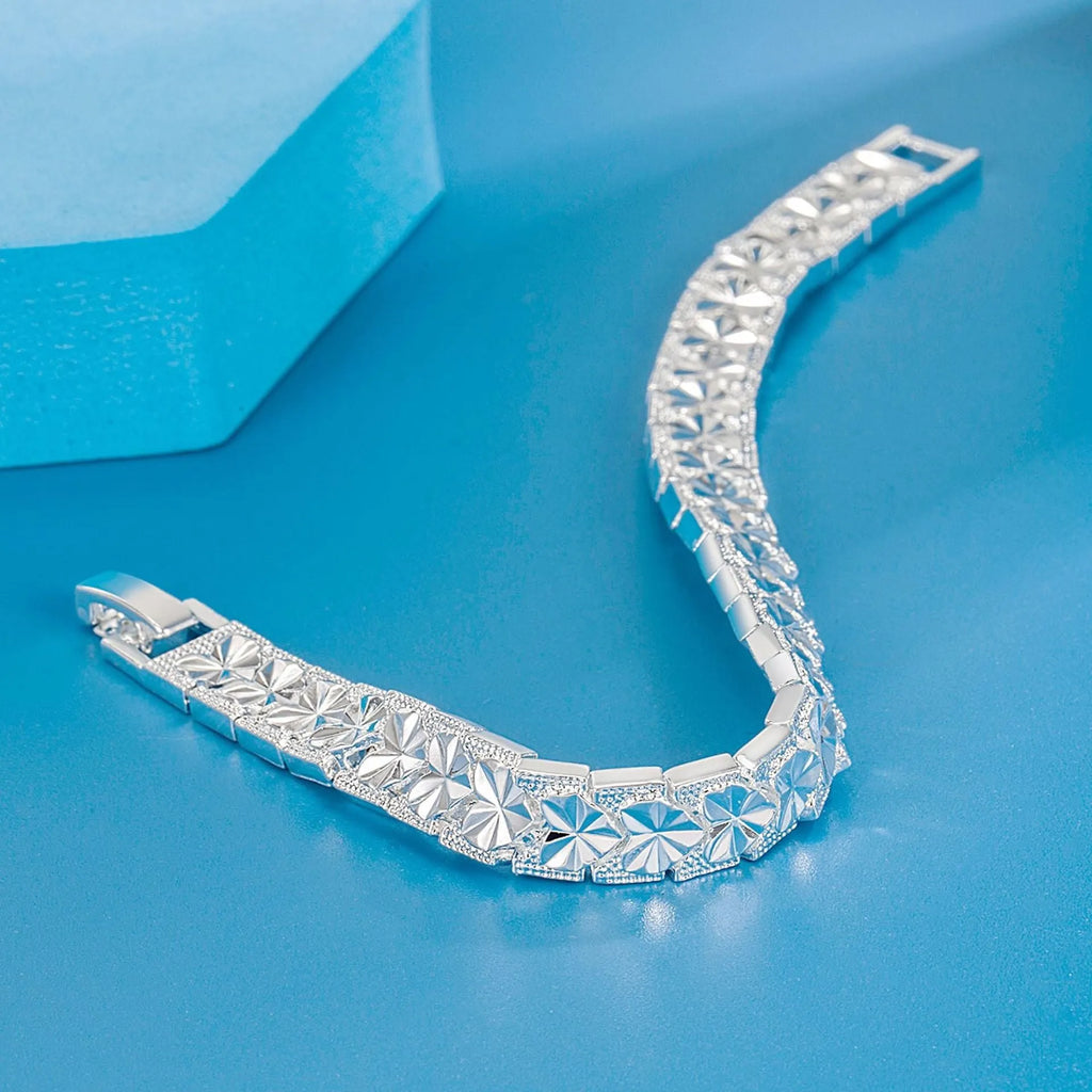 Silver electroplated copper bracelet for women with peach-shaped heart buckle closure on white background