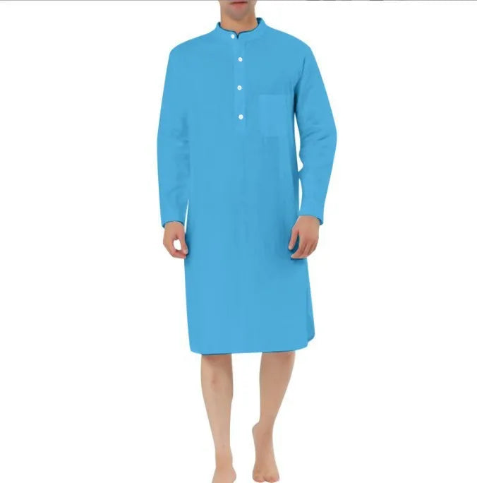 A man wearing a dark blue cotton shirt-style full-length robe for loungewear.