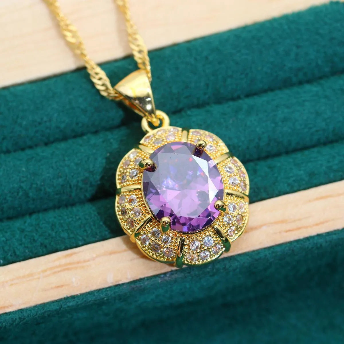 18k gold plated jewellery set showing ring, earrings, bracelet, and necklace with coloured cubic zirconia stones.