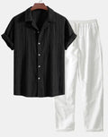 Casual linen suit set with camouflage print, featuring a short-sleeved top and matching trousers.