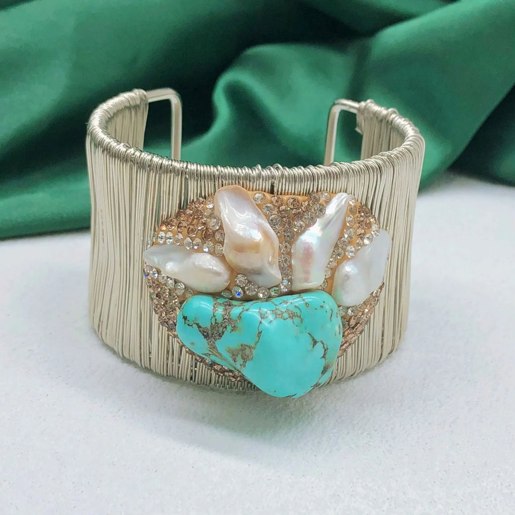Silver coloured women's bracelet with pearl material and diamond inlay in original baroque design
