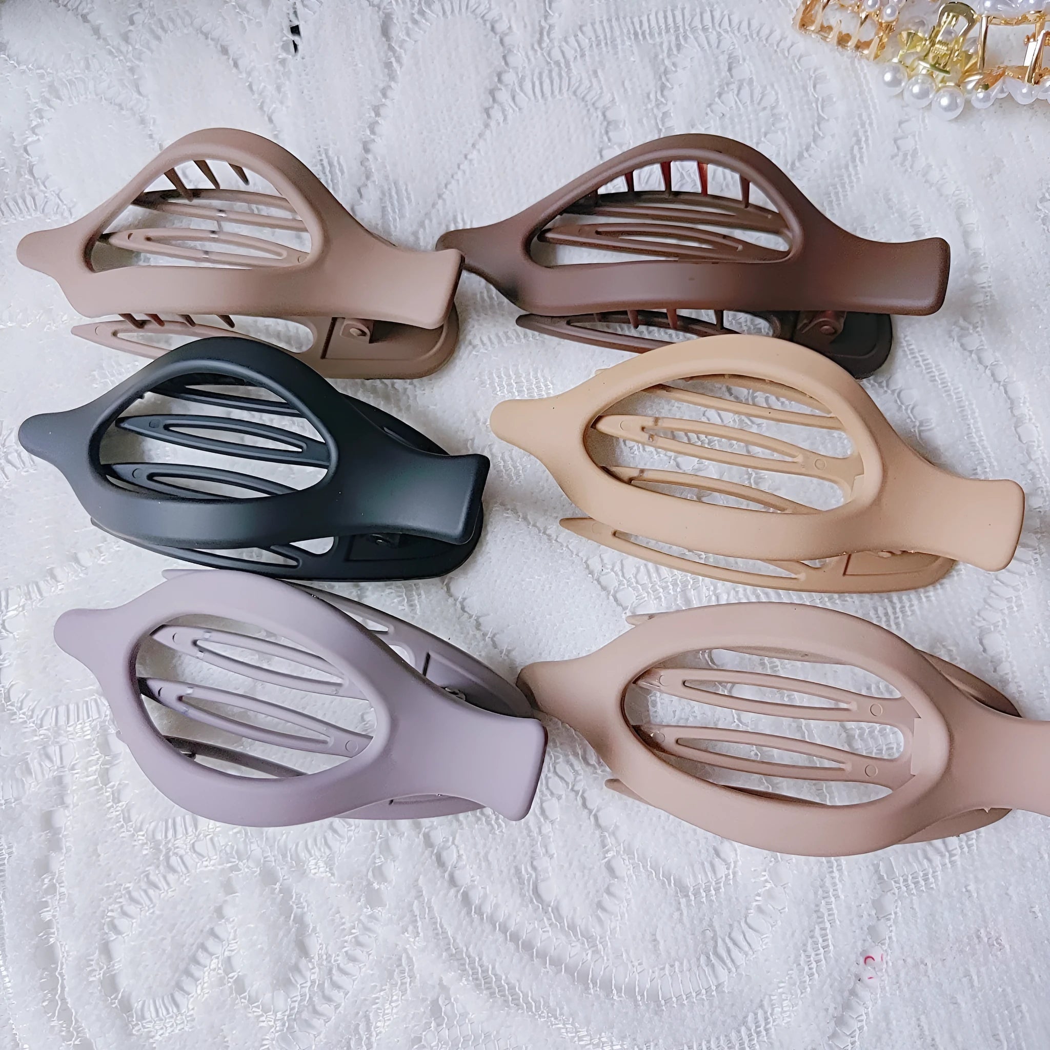Six plastic hair clips with frosted grip texture and quadrilateral design in individual OPP bags