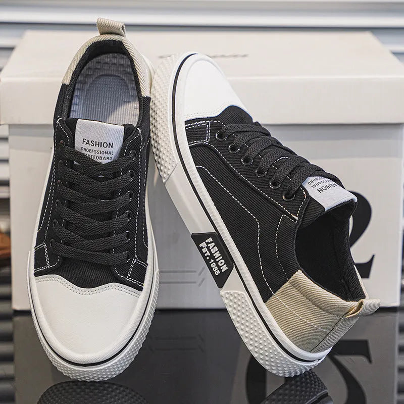 Men's low top casual canvas shoes in blue with round toe and front lace-up, on a plain background.