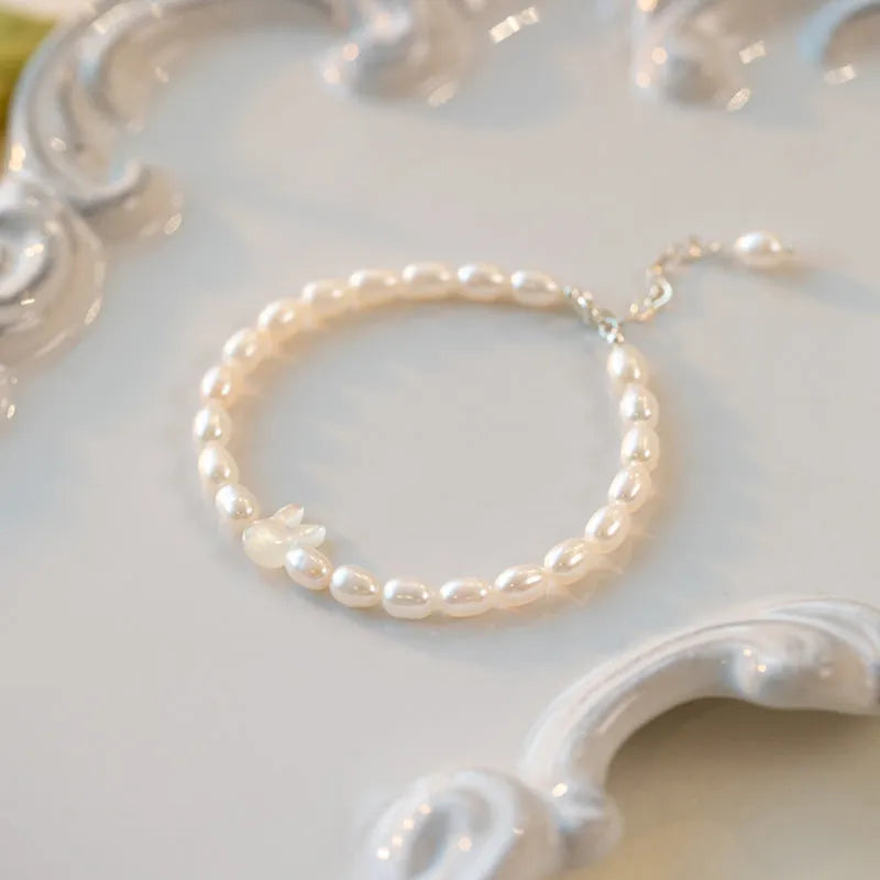 White pearl bead bracelet with 925 silver rabbit charm on elastic string