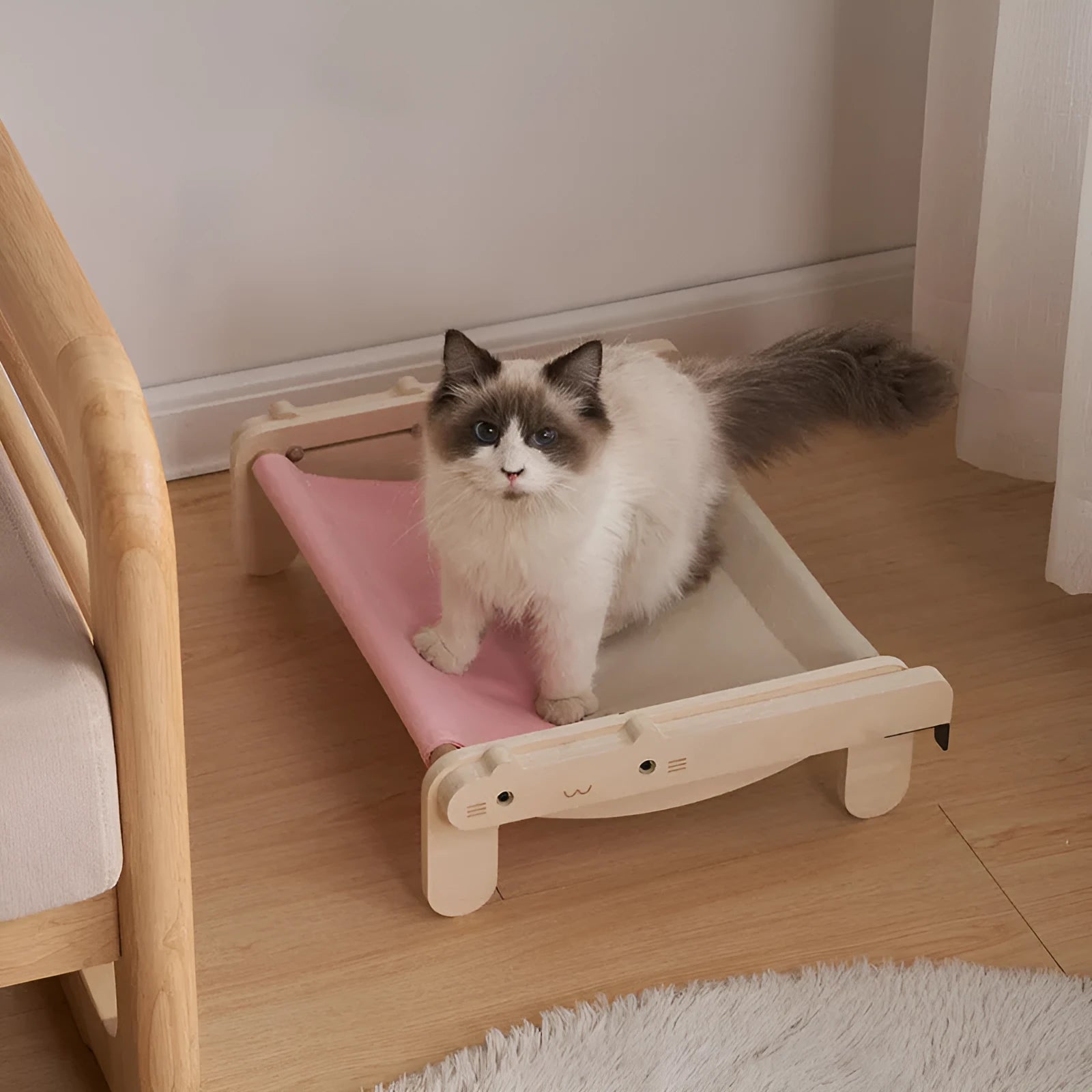 Solid wood cat bed with washable cover in grey-blue colour option on floor