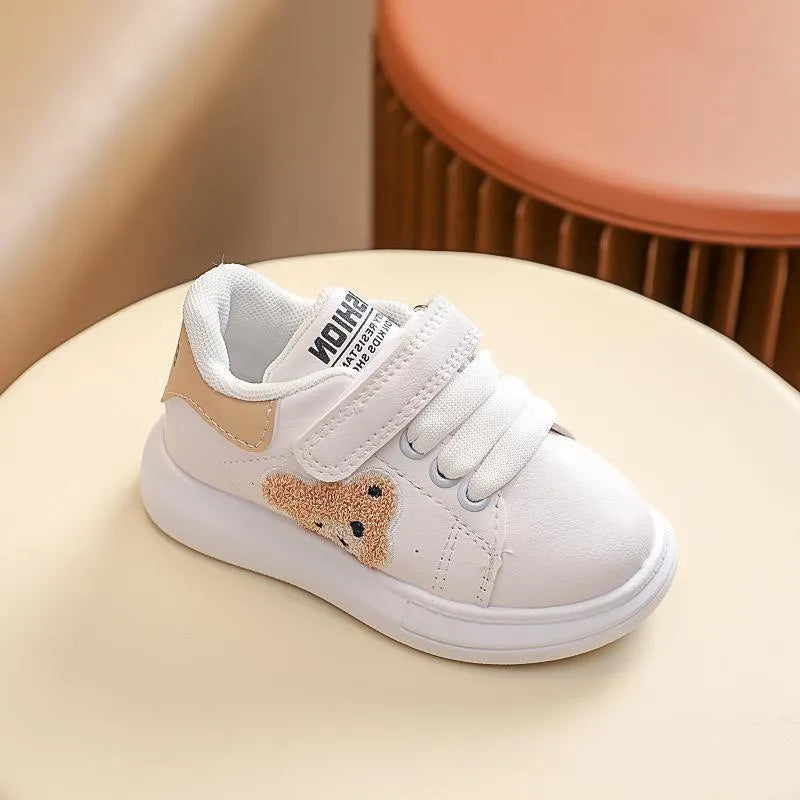 Baby Bear cartoon pattern children's sneakers in green, shown on a white background.
