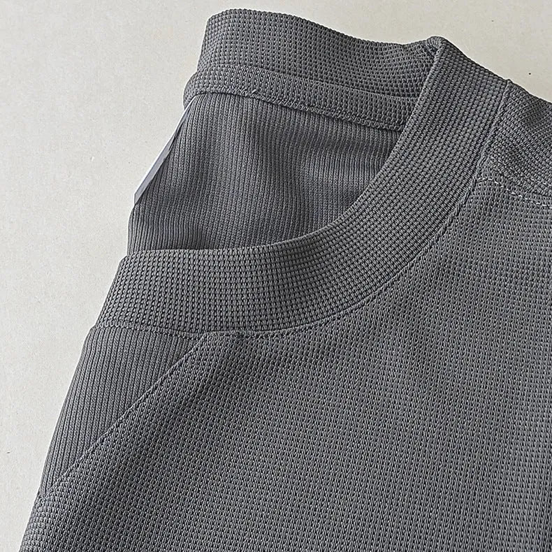 Men's waffle-textured heavy short-sleeved T-shirt in a solid colour, showing detail of fabric texture.