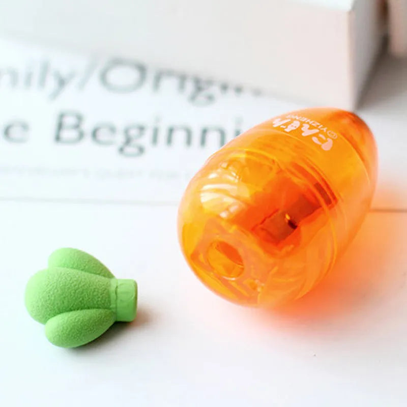 Carrot-shaped orange plastic pencil sharpener with green top, showing compact size next to pencil