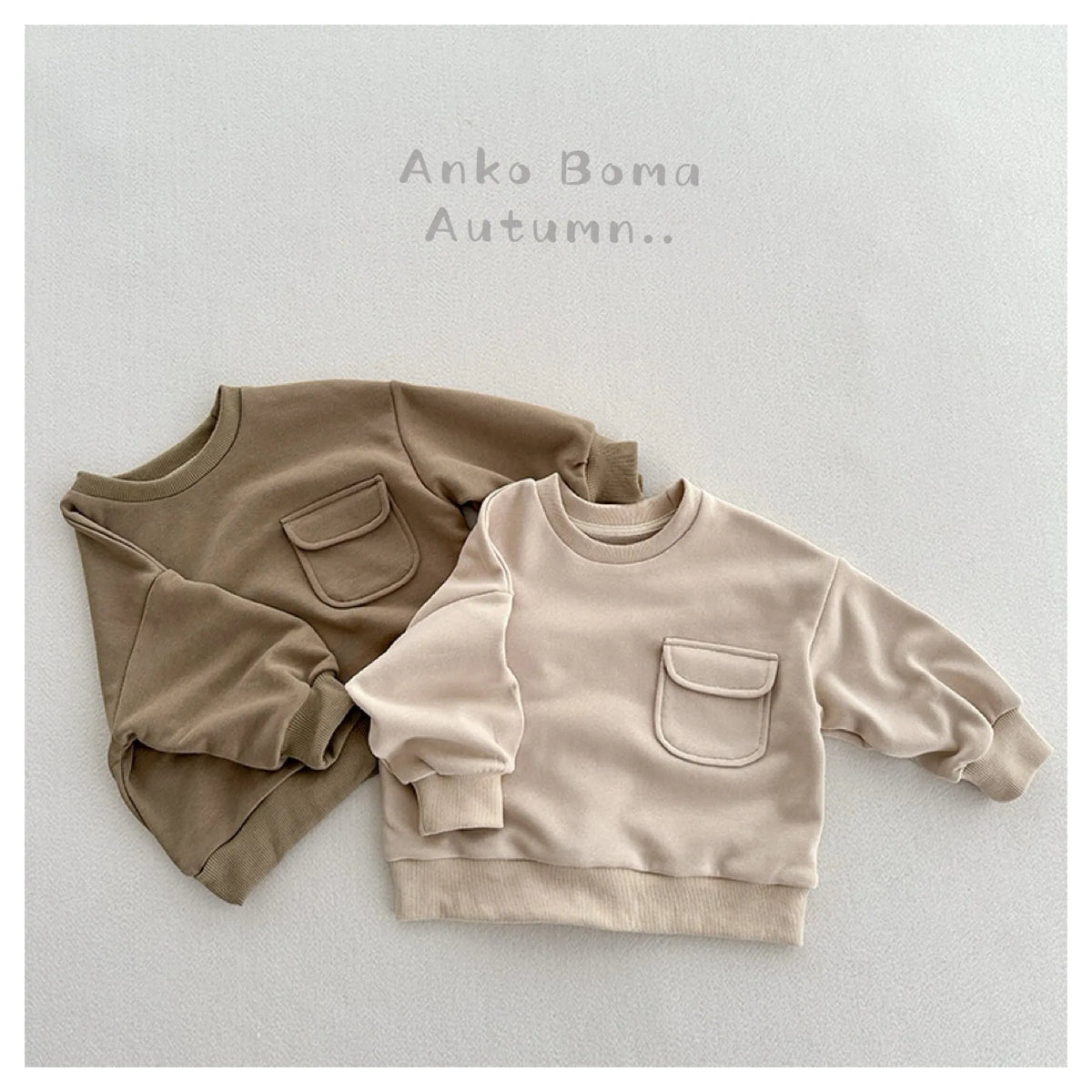 Solid colour cotton pullover for children with loose fit and pockets in Ivory White