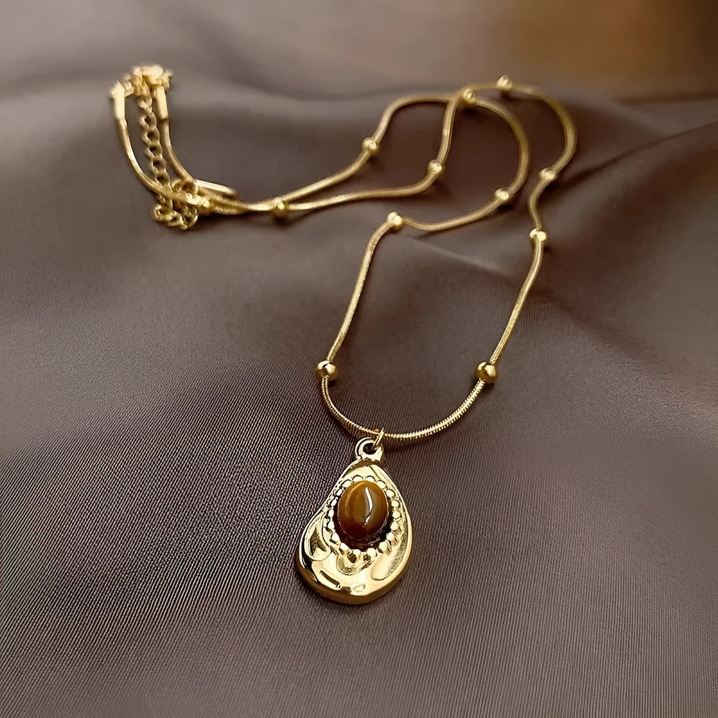 Gold titanium steel clavicle necklace with irregular amber tiger eye stone pendant