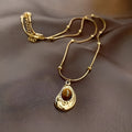 Gold titanium steel clavicle necklace with irregular amber tiger eye stone pendant