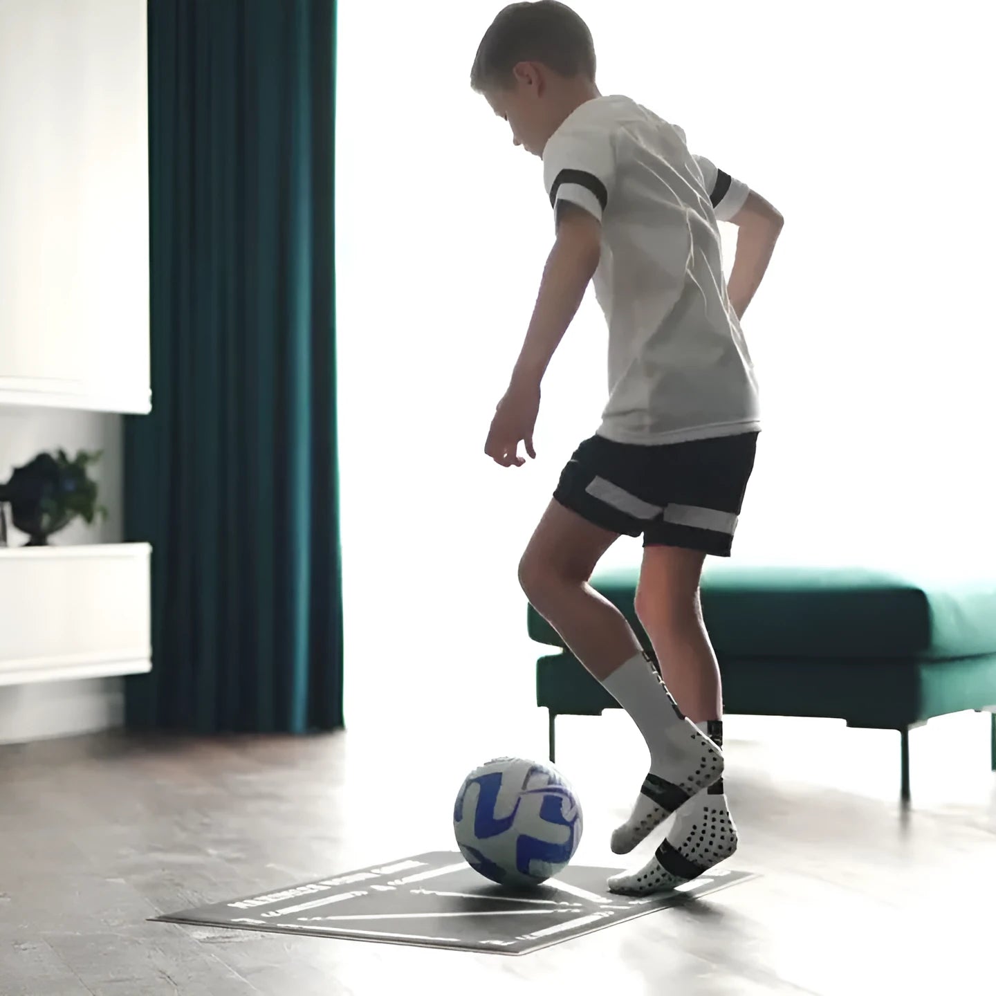 Black football training mat measuring 60cm by 90cm with non-slip surface