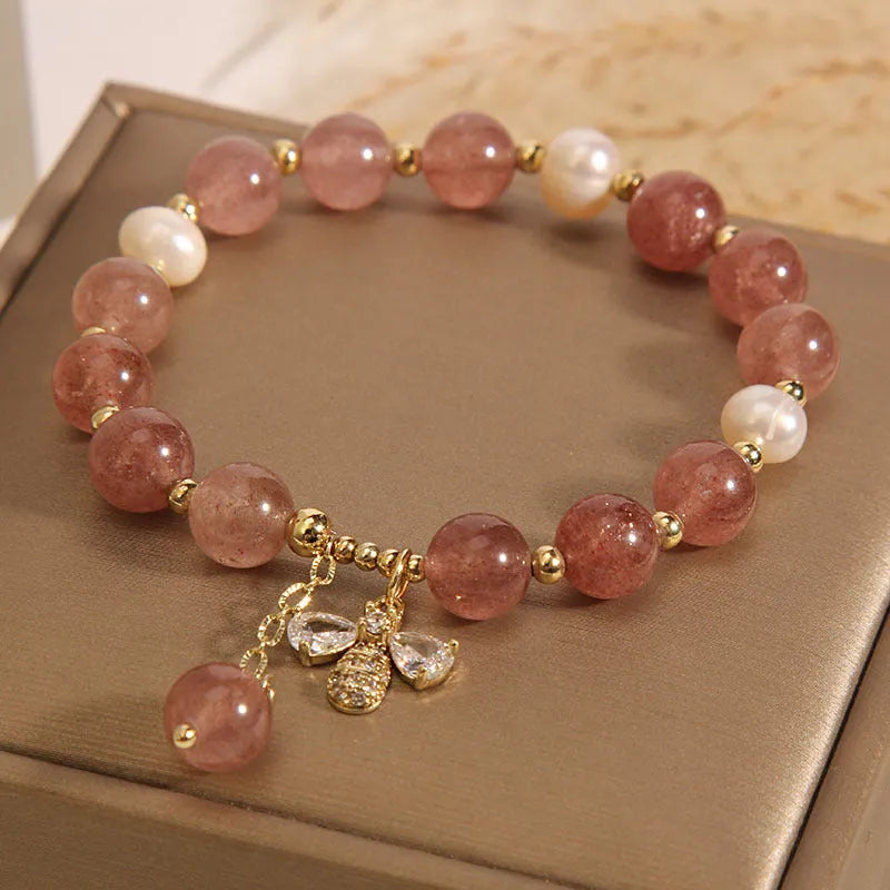 Women's bracelet with strawberry quartz beads, freshwater pearls, and zircon crystals on gold-tone clasp