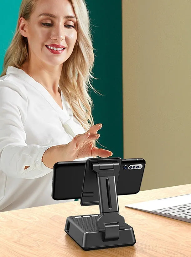 Black mobile phone broadcasting stand with Bluetooth speaker and microphone on desk