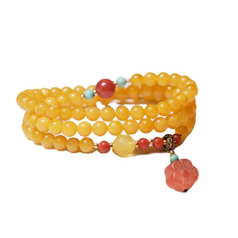 Yellow chicken grease beeswax amber bracelet with 5mm round beads and animal zodiac design.