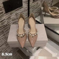 Women's black pointed patent leather stiletto high heel shoes with a glossy finish.